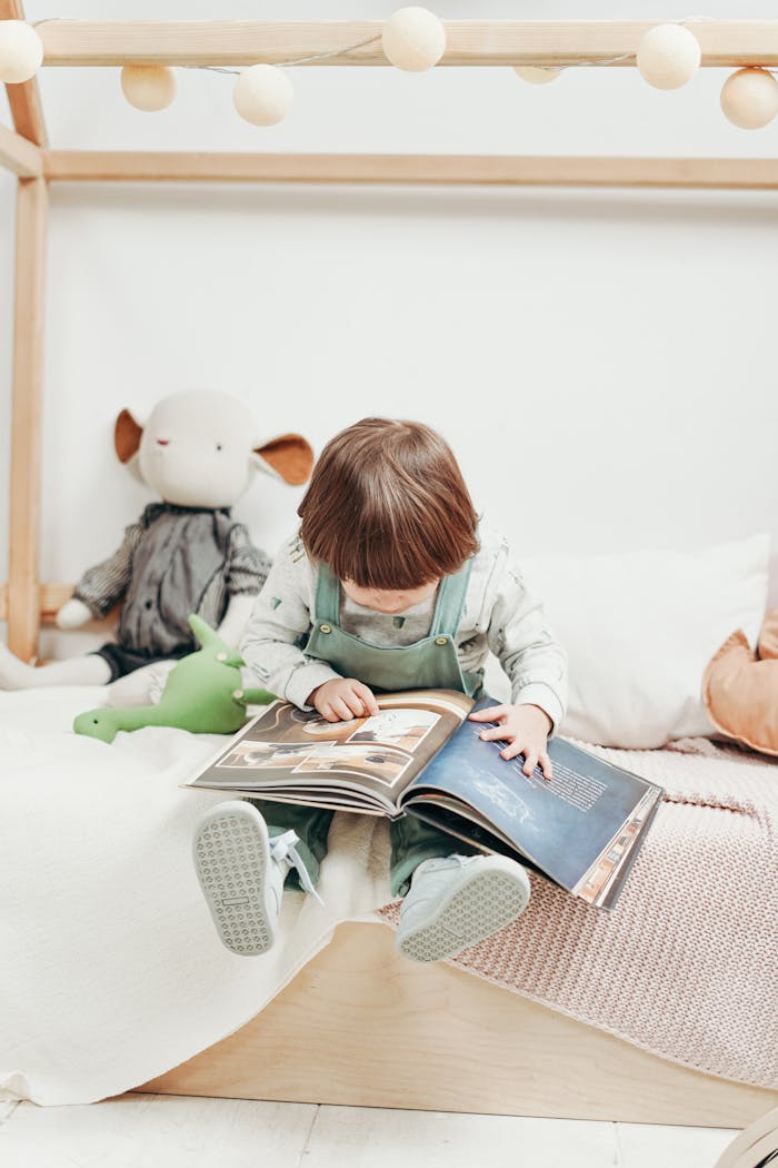 why-choose-us-02 Adorable child reading a book in a cozy playroom, surrounded by toys. Perfect for early learning themes.